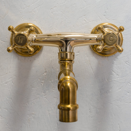 The Francone BT25S unlacquered brass wall-mounted faucet features a custom-made swivel spout.