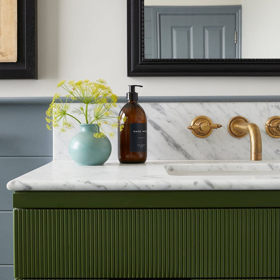 Traditional Francone BT68 solid brass wall-mounted faucet with handcrafted Edwardian handles installed in a bathroom.