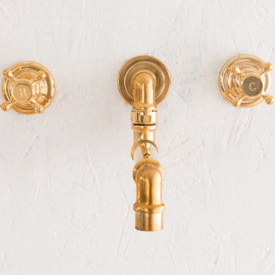 Francone BT70 traditional wall-mounted brass faucet with a swivel spout and crosshead handles.