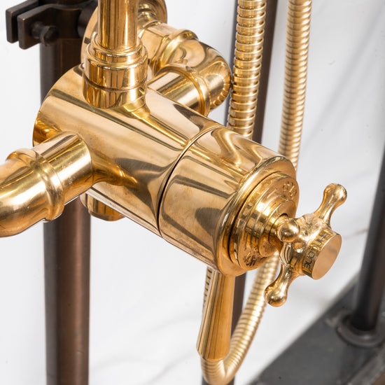 A close-up detail of the traditional Francone BTS26T thermostatic hand shower in solid unlacquered brass.