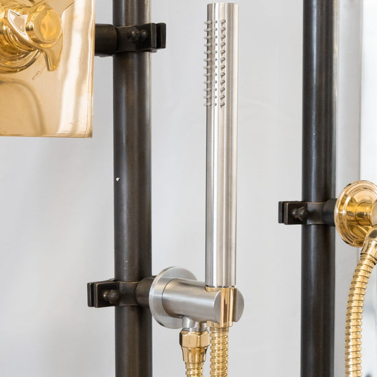 A detailed view of the Francone SSS23 handcrafted solid brass hand-held shower in mixed metals.