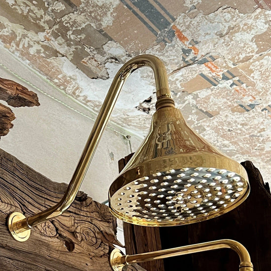 Detail of the Francone BTS54 traditional unlacquered brass wall-mounted shower with a classic bell showerhead.