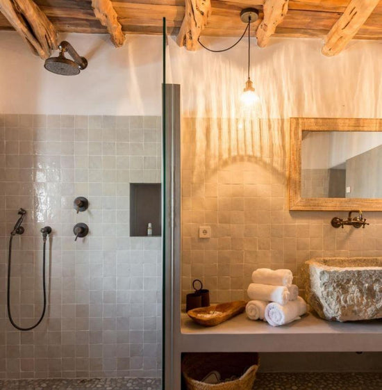 An installed Francone BTS7 solid brass wall-mounted shower and mixer faucet in a rustic bathroom.