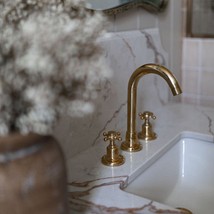 Traditional Francone BT1 unlacquered brass three-hole basin faucet installed on a marble bathroom vanity by Styled Living