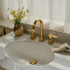 Artisanal Francone BT1 three-hole basin faucet in unlacquered brass, installed on a marble sink.