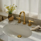 Artisanal Francone BT1 three-hole basin faucet in unlacquered brass, installed on a marble sink.