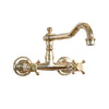 Traditional Francone BT12 wall-mounted bathroom faucet in unlacquered brass with a swivel spout and cross handles.