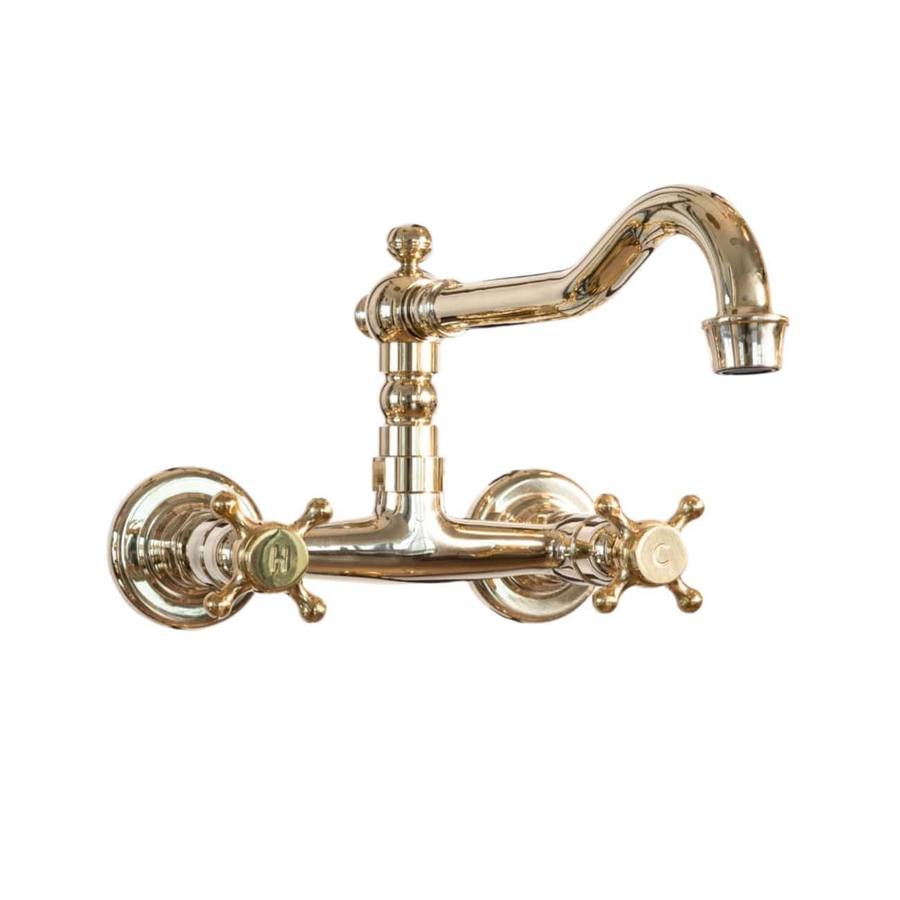Traditional Francone BT12 wall-mounted bathroom faucet in unlacquered brass with a swivel spout and cross handles.