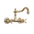 Traditional Francone BT12 wall-mounted bathroom faucet in unlacquered brass with a swivel spout and cross handles.