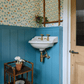 Francone BT15 traditional unlacquered brass bathroom tap installed in blue wood-paneled bathroom by Palmer & Stone, Mel Architects, photo Christ Snook