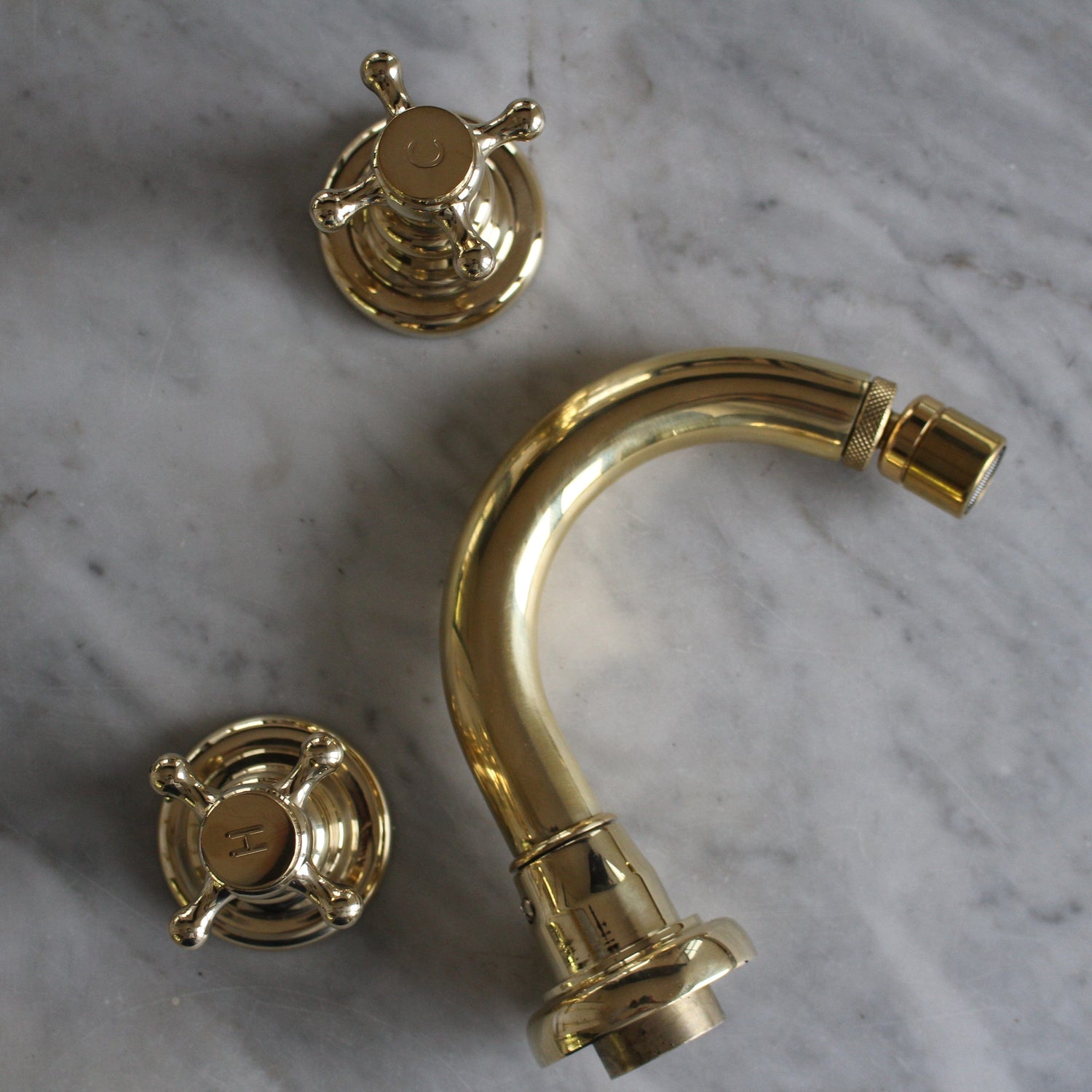 Francone BT1B traditional three-hole bidet faucet in unlacquered brass, deck mounted on marble.