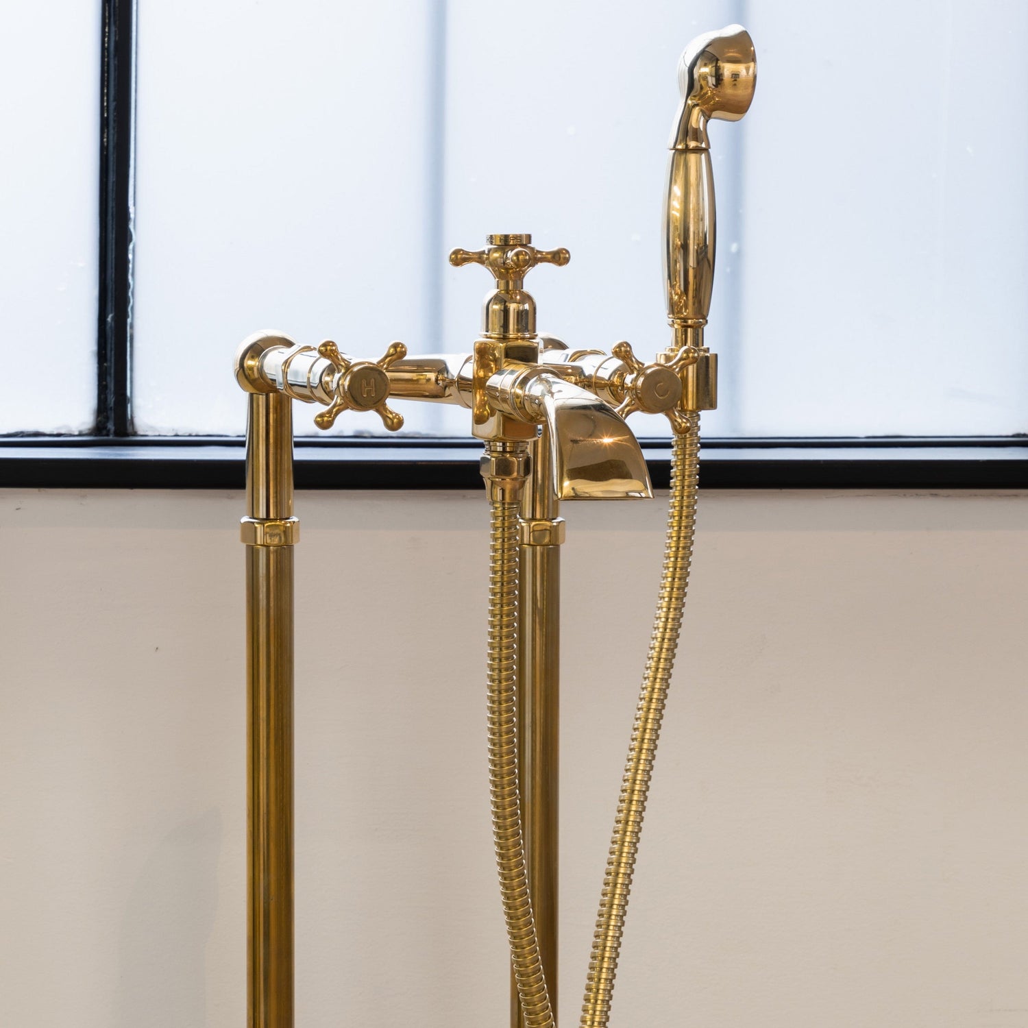Francone BT25+F traditional floor-mounted bath filler faucet and hand shower in unlacquered brass.