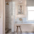 Traditional Francone BT26 unlacquered brass wall mounted bath filler faucet installed in a marble bathroom by Polly Ashman