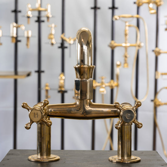 Francone BT29 traditional unlacquered brass deck mounted tap with double cross handles featuring H and C for hot and cold.