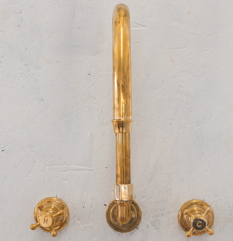 Traditional Francone BT32 wall-mounted bespoke unlacquered brass faucet with a swivel spout and hot/cold taps.