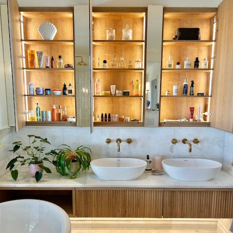 Installed Francone BT34 wall-mounted unlacquered brass faucet and taps over marble basins, styled by 1907 House.
