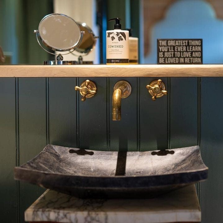 Francone BT34 unlacquered brass wall-mounted faucet installed above a stone basin by Cambridge Country Cottages.