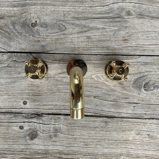 Francone BT34XL traditional unlacquered brass wall-mounted bathroom taps and faucet on a wood background.