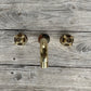 Francone BT34XL traditional unlacquered brass wall-mounted bathroom taps and faucet on a wood background.