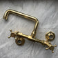 Traditional unlacquered brass wall-mounted bathroom faucet, the Francone BT40S bespoke tap on marble.