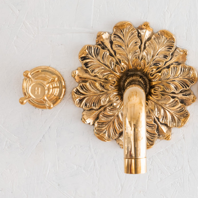 Francone BT44 wall mounted tap with an unlacquered brass ornamental plate and a circular hot water handle.