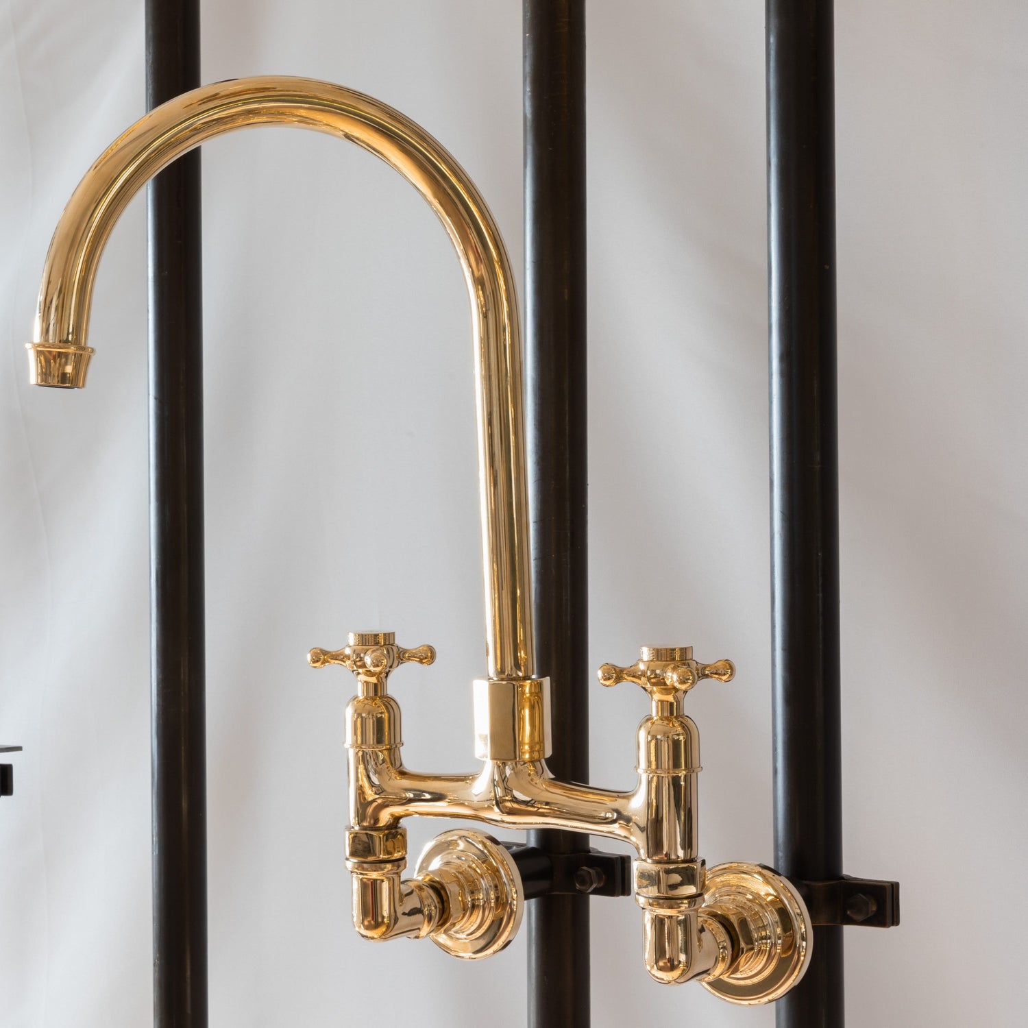 Francone BT49W traditional wall-mounted kitchen faucet in unlacquered brass with a curve swivel spout.
