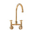 Traditional wall-mounted kitchen faucet in unlacquered brass, the Francone BT49W tap features a curved spout.