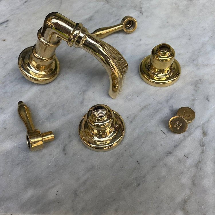Unlacquered brass components of the Francone BT50 traditional deck-mounted bath tap faucet.