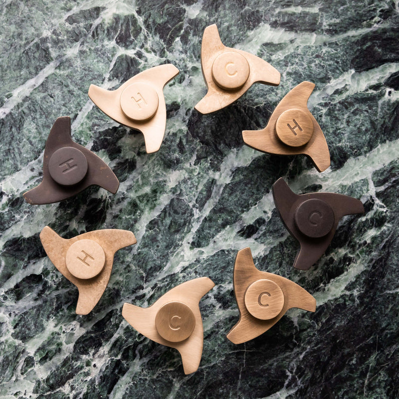 Francone BT55 bathroom faucet spinner handles shown in a selection of mixed metal finishes.