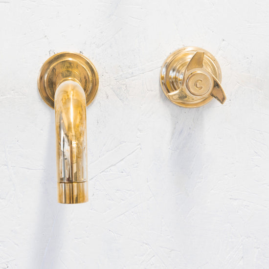 Francone BT55 wall-mounted unlacquered brass bathroom tap faucet with a three-prong spinner handle.