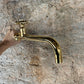A hand holding the traditional Francone BT59T wall-mounted solid brass tap, a luxury bathroom faucet.