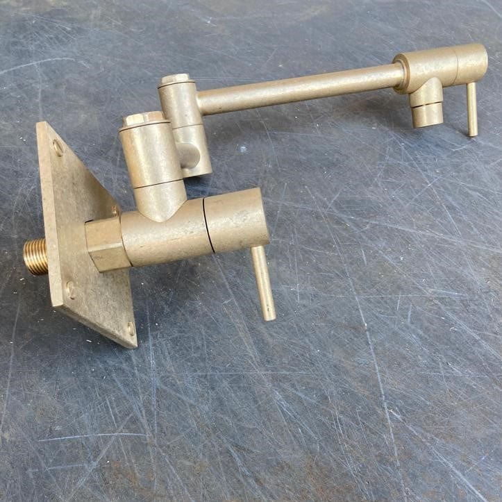 A handcrafted Francone BT6 unlacquered brass kitchen pot filler faucet with a double-jointed arm.