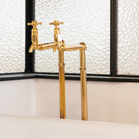 A close-up of the traditional Francone BT62 unlacquered brass floor mounted bath filler faucet.