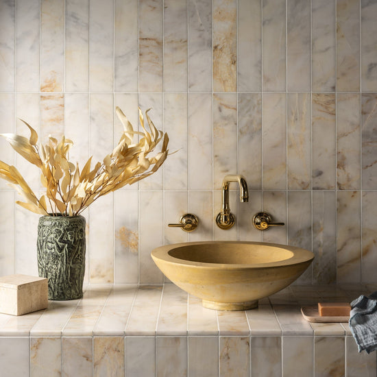 Francone BT65 wall-mounted traditional faucet in solid brass, installed above a yellow stone basin.