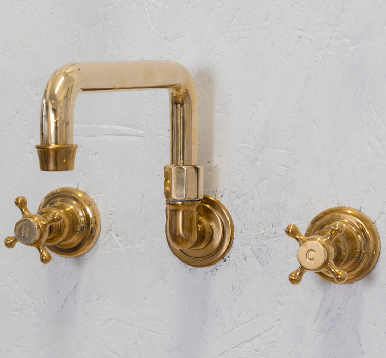 Traditional Francone BT65 wall-mounted unlacquered brass bathroom tap with a swivel bridge spout.