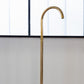 Francone BT67 unlacquered brass floor-mounted bathroom faucet with a curved gooseneck spout.