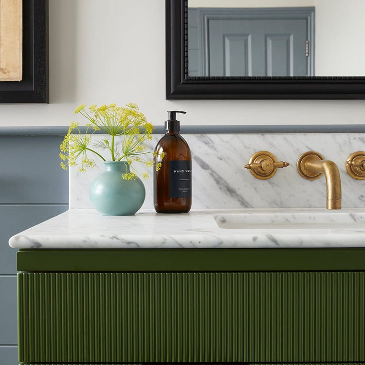 Traditional Francone BT68 solid brass wall-mounted faucet with handcrafted Edwardian handles installed in a bathroom.
