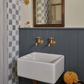 Traditional Francone BT72 unlacquered brass wall-mounted faucets installed over a white bathroom basin.