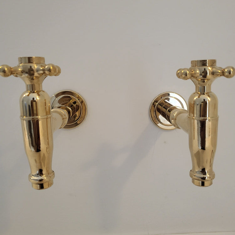 Francone BT73 traditional beer-style bib taps in unlacquered brass, perfect as a wall-mounted bathroom faucet.