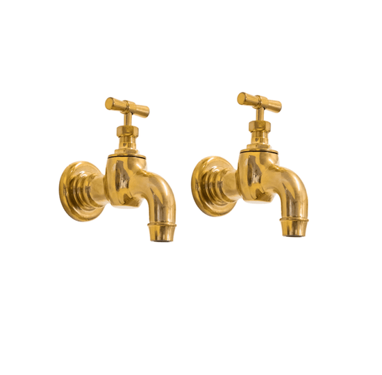 A pair of traditional Francone BT74 wall mounted bib taps in unlacquered brass, also used as bathroom faucets.