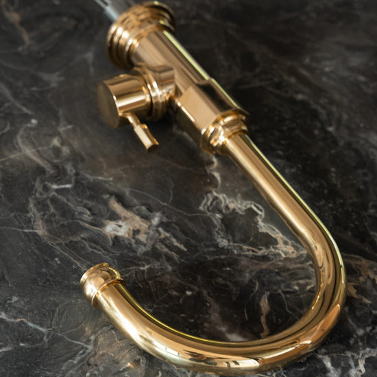 A detail of the handcrafted Francone BT7CY unlacquered brass kitchen mixer tap, featuring a curved swivel spout.