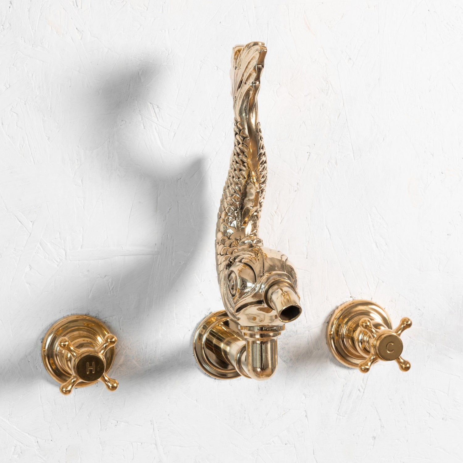 Francone BT81W wall-mounted traditional brass faucet with an ornamental fish spout and cross handles.