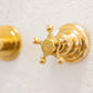 Detail of a traditional Italian unlacquered brass Francone BT82 bathroom faucet star handle.