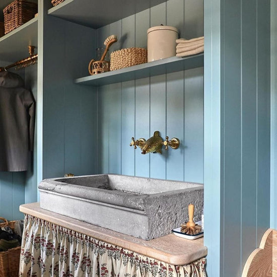 Bespoke Francone BT86 wall-mounted brass faucet with an ornamental fish head spout installed in a blue bathroom.
