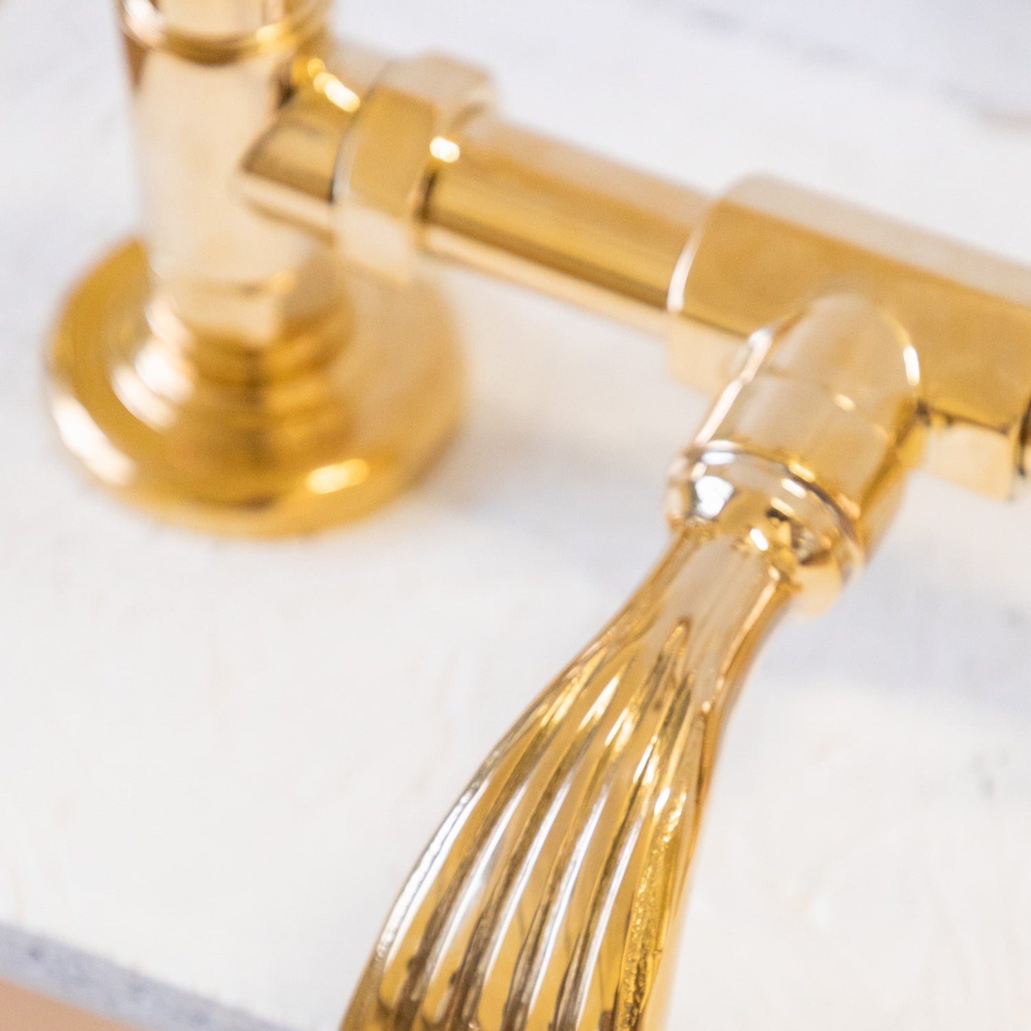 Detail of a traditional gold plated solid brass Francone BT89S deck mounted faucet handle.