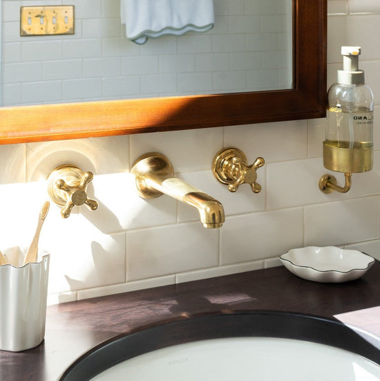 Francone BT91 traditional wall-mounted brass bathroom faucet with hot and cold handles, installed in a vintage sink.