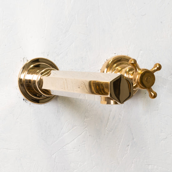 Detail of the Francone BT99 wall-mounted hexagonal faucet in unlacquered brass, handcrafted in Italy.