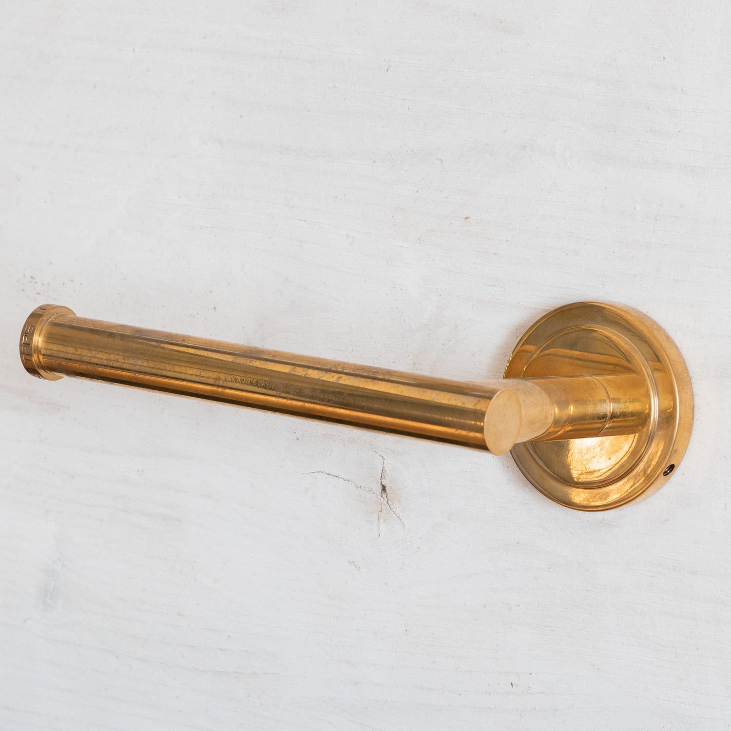 Wall-mounted Francone BTA20 toilet roll holder in solid unlacquered brass.