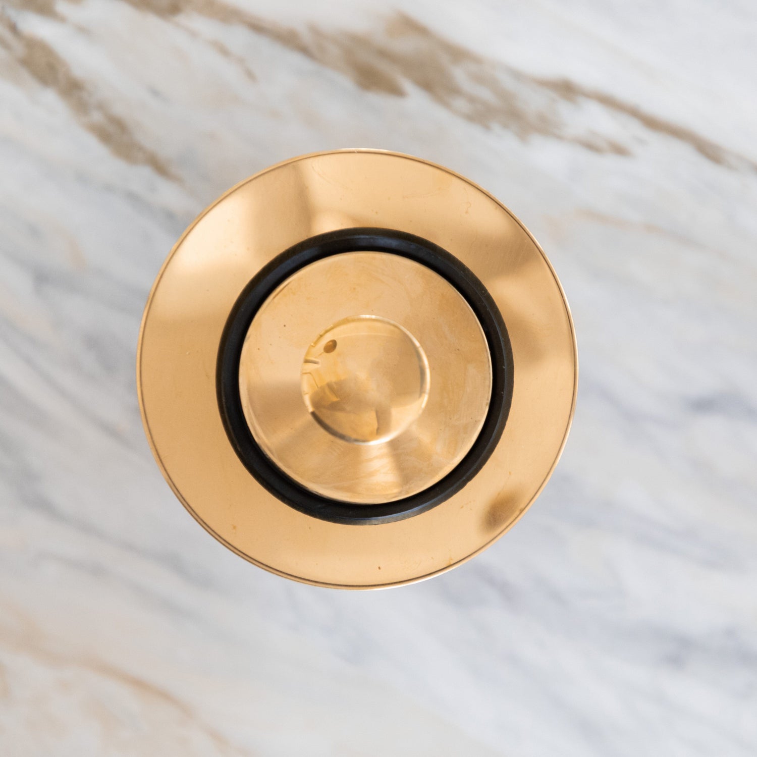 Traditional round Francone BTA2S basin waste plug in unlacquered brass, top-down view.
