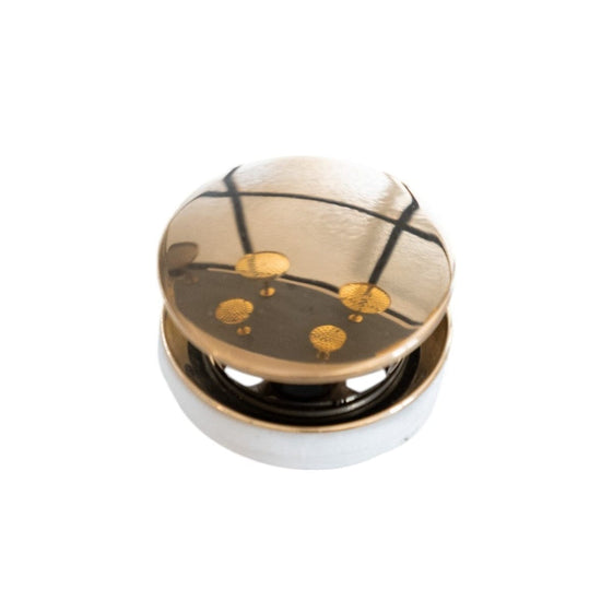 Francone BTA4 circular click-clack basin waste plug in unlacquered brass for luxury bathrooms.